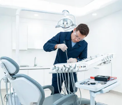 Field service engineer servicing dental equipment
